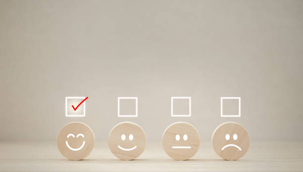 istock emotion faces on wooden cubes arranged on table for satisfaction survey 1423273961