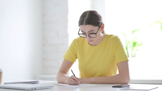 istock Woman having Disappointment while Writing on Pape 1423274028