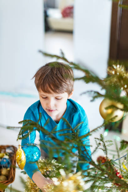 istock Little boy decorating Christmas tree 1423274406