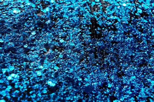 Baby blue glitter background. Selective focus. Beautiful sparkle
