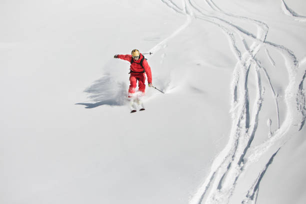 istock Young adult man skiing in mountains 1423275997