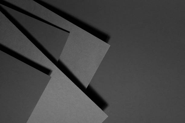 istock Dark grey carbon textured abstract geometric background with soar stepped rectangle surfaces with angles and black shadow lines in graphic minimalist monochrome business style, top view, copy space. 1423276096
