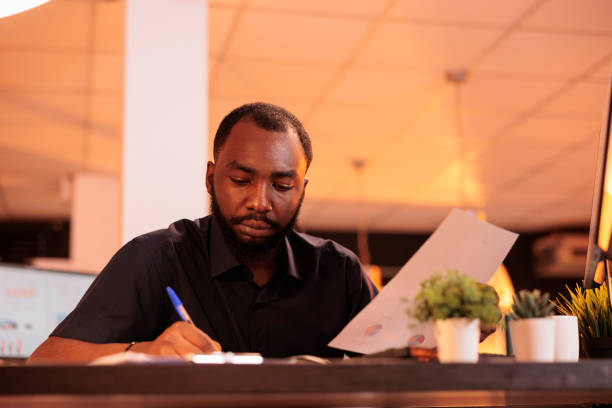 istock African american employee taking notes about startup contract 1423276389