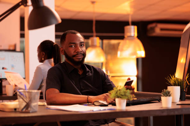 istock Portrait of young worker using smartphone app at office job 1423276569