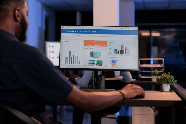 istock Executive manager looking at computer monitor with charts 1423277438
