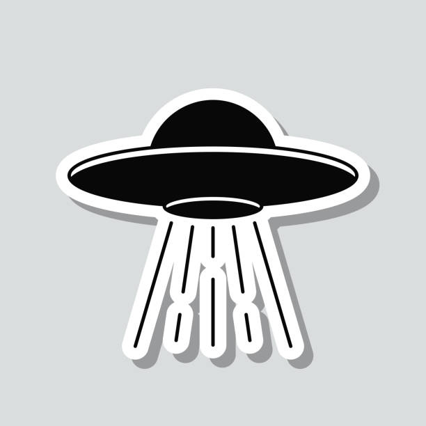 UFO - Flying saucer with light beam. Icon sticker on gray background Icon of "UFO - Flying saucer with light beam" on a sticker with a drop shadow isolated on a blank background. Trendy illustration in a flat design style. Vector Illustration (EPS file, well layered and grouped). Easy to edit, manipulate, resize or colorize. Vector and Jpeg file of different sizes. grey alien stock illustrations