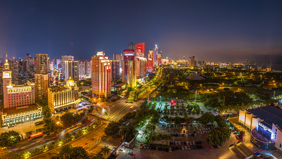 The view of Haikou City in Hainan Island. Many building equipped with beautiful decorated light in this road. Made from 9 photos that blended as one panorama picture.