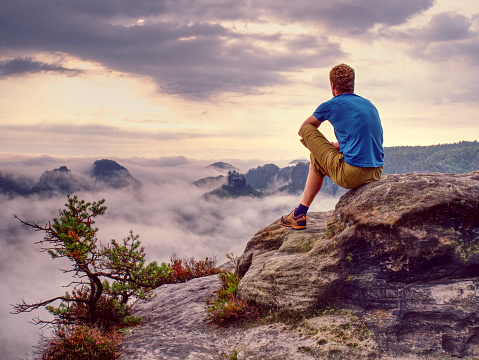 Man standing on the top of mountain.