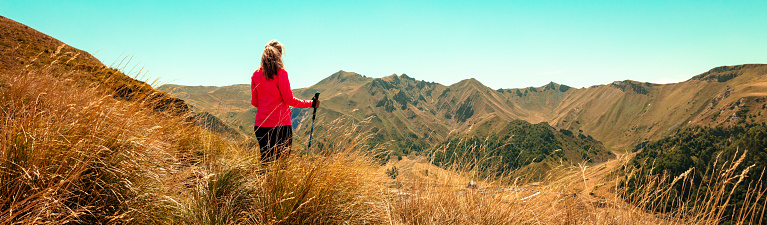 woman looking at panoramic Puy de Sancy viewpoint