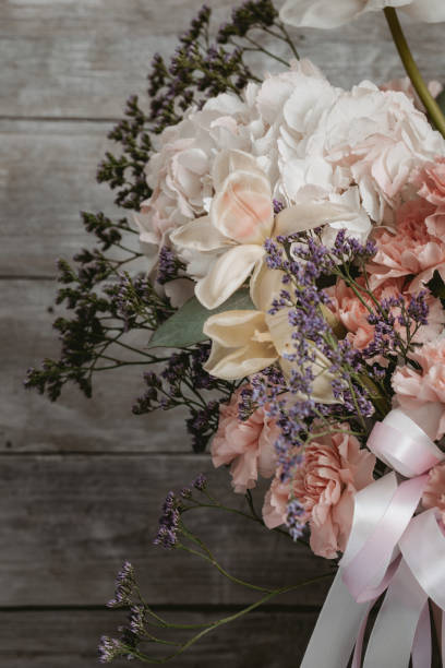 istock Beautiful flowers composition on wooden background 1423283019