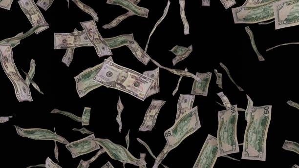 istock 50 Dollar bills falling down. Banknotes isolated on black background. 1423284558