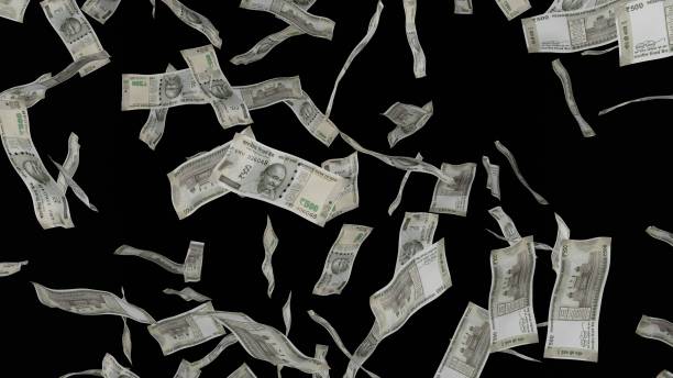 istock 500 Indian Rupee bills falling down. Banknotes isolated on black background. 1423284583