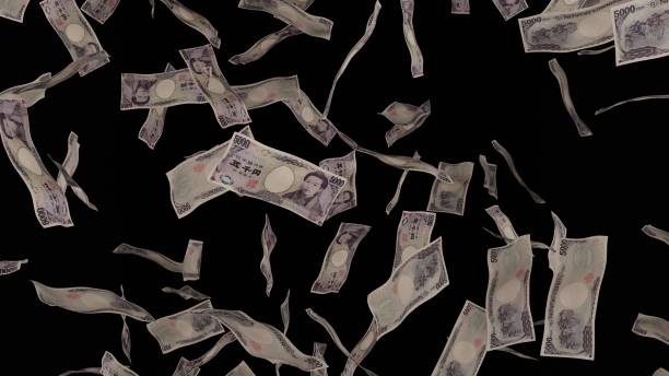 istock 5000 Japanese Yen bills falling down. Banknotes isolated on black background. 1423284600