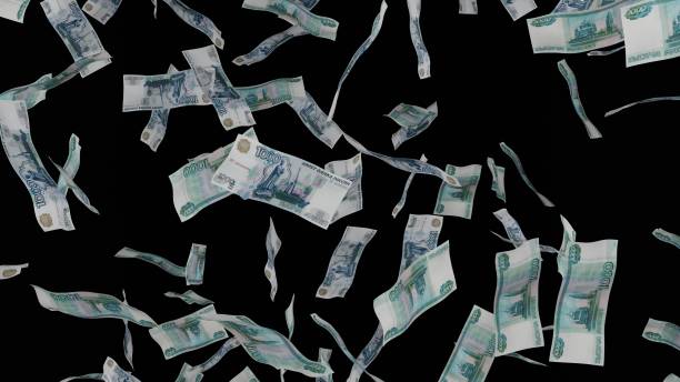 istock 1000 Russian Ruble bills falling down. Banknotes isolated on black background. 1423284605