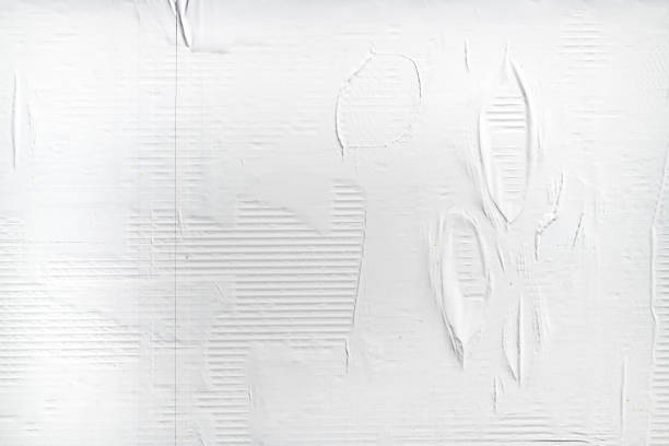 istock Crumpled white advertising poster paper as copy space and background. Graphic design element. 1423286887