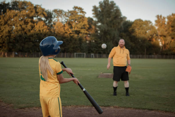 istock Baseball father and daughter working hard during a softball coaching session 1423287148