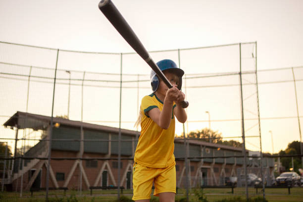 istock Baseball girl on a diamond with a baseball bat 1423287196