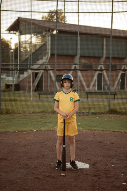 istock Baseball girl on a diamond with a baseball bat 1423287205