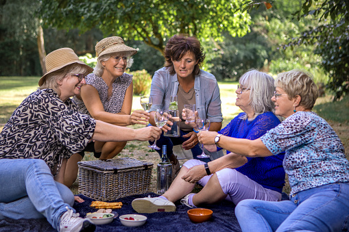 Picnic stop for small group of senior women on an outdoor adventure