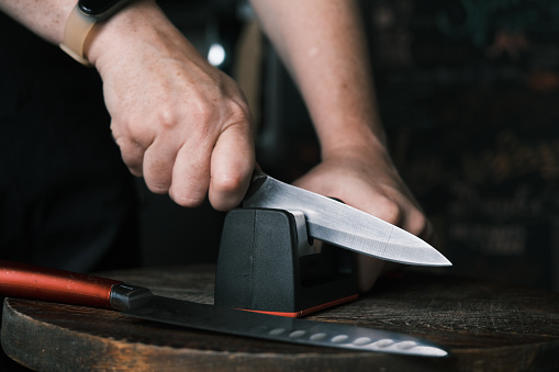 An assortment of different kitchen knives on a cutting board