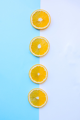 Slices of orange on a blue and white background
