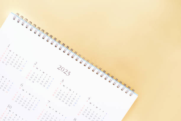 istock White calendar for 2023 on golden background close-up, planning concept. 1423293396