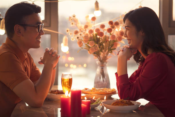 young asian couple eating dinner together - dating restaurant dinner couple imagens e fotografias de stock