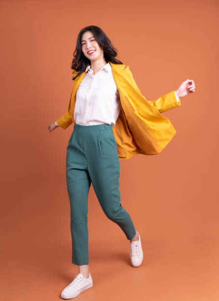 Full length photo of young Asian woman on background Full length photo of young Asian woman on background full body isolated stock pictures, royalty-free photos & images