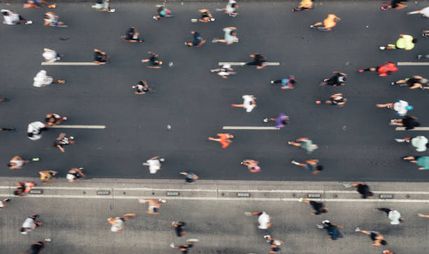 istock Aerial view of people running 1423295594