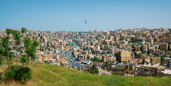 Amman skyline in Jordan. Sunny day view of the old downtown of Jordanian capital city built on seven hills from a high altitude on a clear sunny day