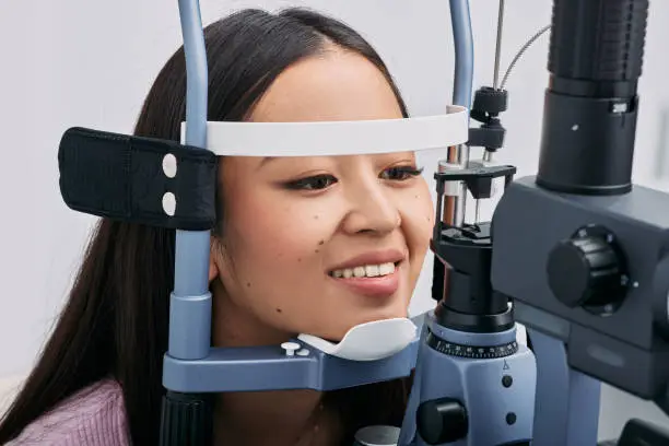Beautiful Asian woman check-up her eyesight in ophthalmological clinic. Patient in ophthalmology clinic