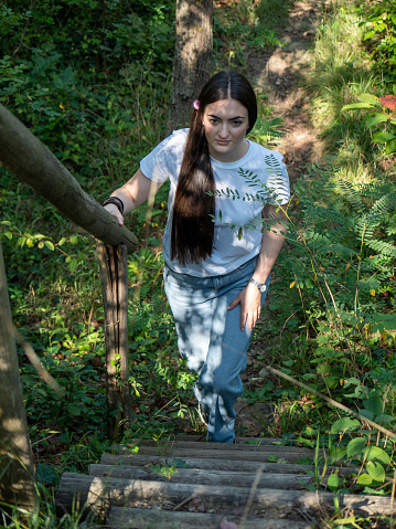 fit female walking outdoors in the wood