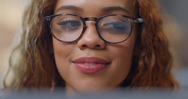 istock Woman, macro and reading screen with glasses for project assignment study on digital tech device. Freelance worker or student doing research online with trendy spectacles for radiation protection. 1423301260