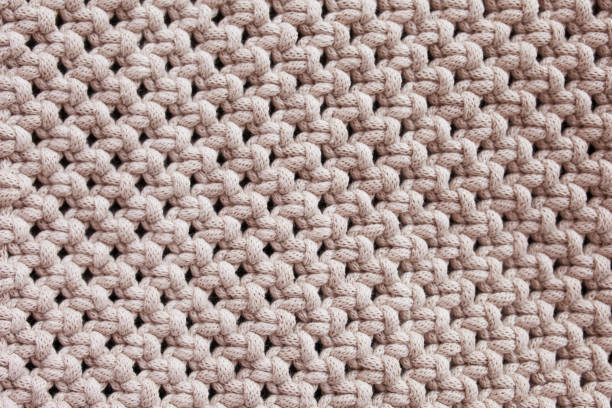 istock Handmade macrame pattern close up. Macrame braiding and cotton threads.  Female hobby.  ECO friendly modern knitting DIY natural decoration concept in the interior. 1423302322