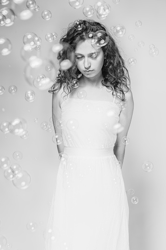 Portrait of dreamy girl with soap bubbles