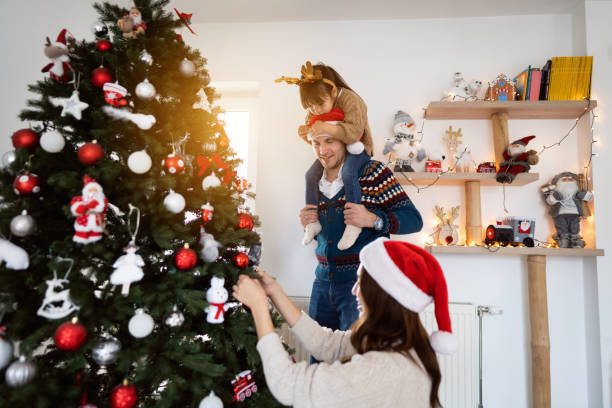 istock Multiracial family decorating Christmas tree together 1423304613