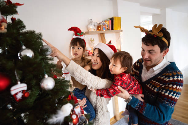 istock Multiracial family decorating Christmas tree together 1423304717