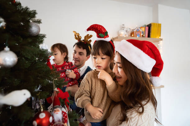 istock Multiracial family decorating Christmas tree together 1423304719