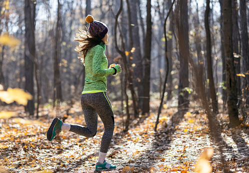 Young woman jogging in the forest