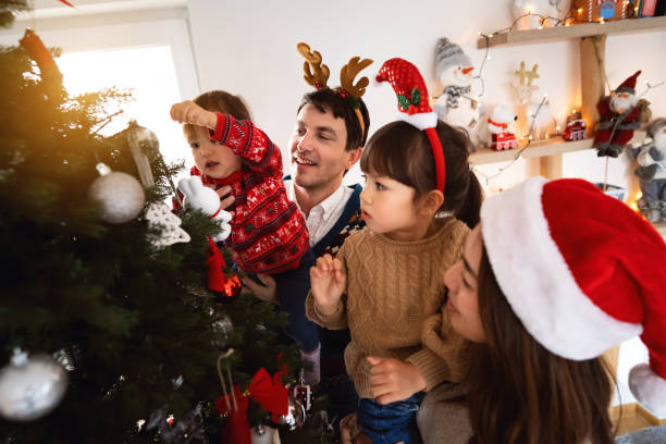 istock Multiracial family decorating Christmas tree together 1423304725