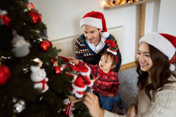 istock Multiracial family decorating Christmas tree together 1423304756