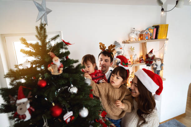 istock Multiracial family decorating Christmas tree together 1423304823
