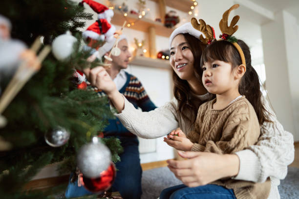 istock Multiracial family decorating Christmas tree together 1423304829