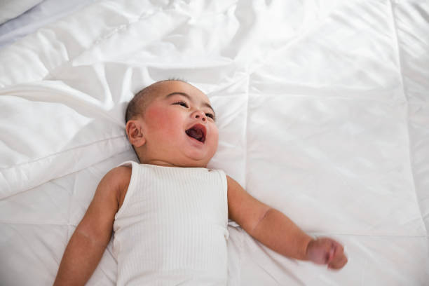 istock Asian cute little baby on bed under soft blanket 1423306859
