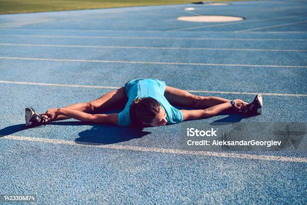 Track Stretch Athletic Female Practicing Full Split Stretch On Running Track Stock ...