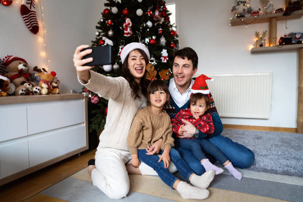 istock Multiracial family taking selfie during Christmas morning 1423307596