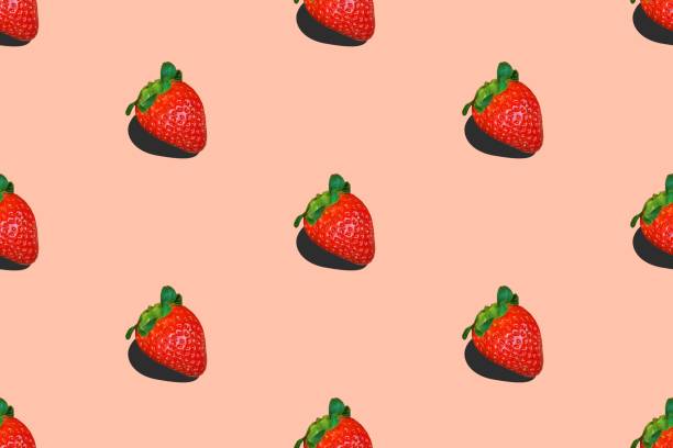 istock Seamless food pattern from ripe strawberries on pink background 1423308435