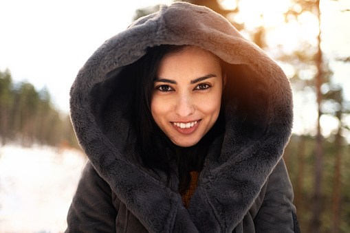 Portrait of beautiful young Caucasian woman in nature during winter