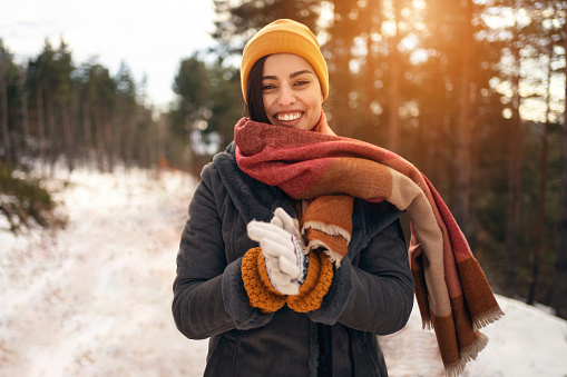 Portrait of beautiful young Caucasian woman in nature during winter