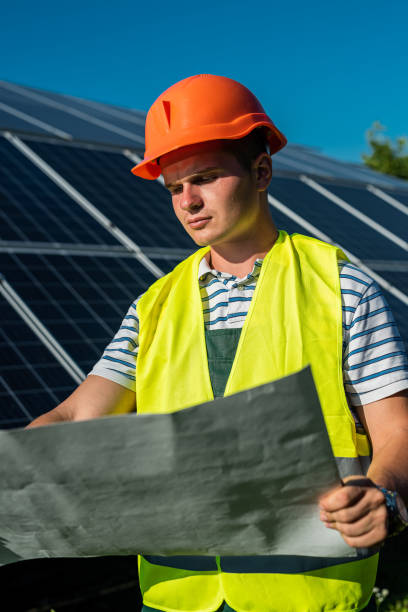 istock young engineer near solar panel and worker holding blueprint, photovoltaic 1423310085